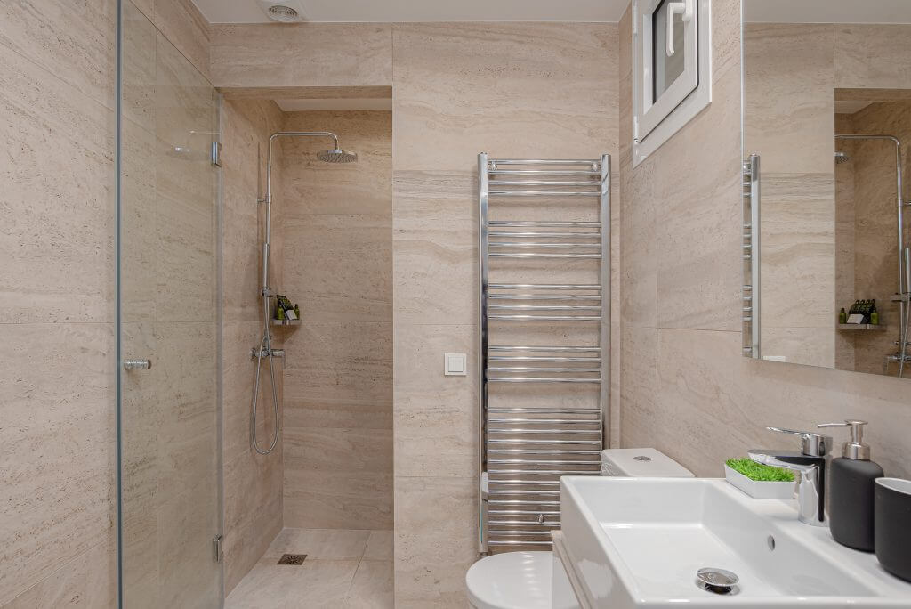 Sophisticated bathroom with walk-in shower and heated towel rack in Kolonaki Luxury Residence