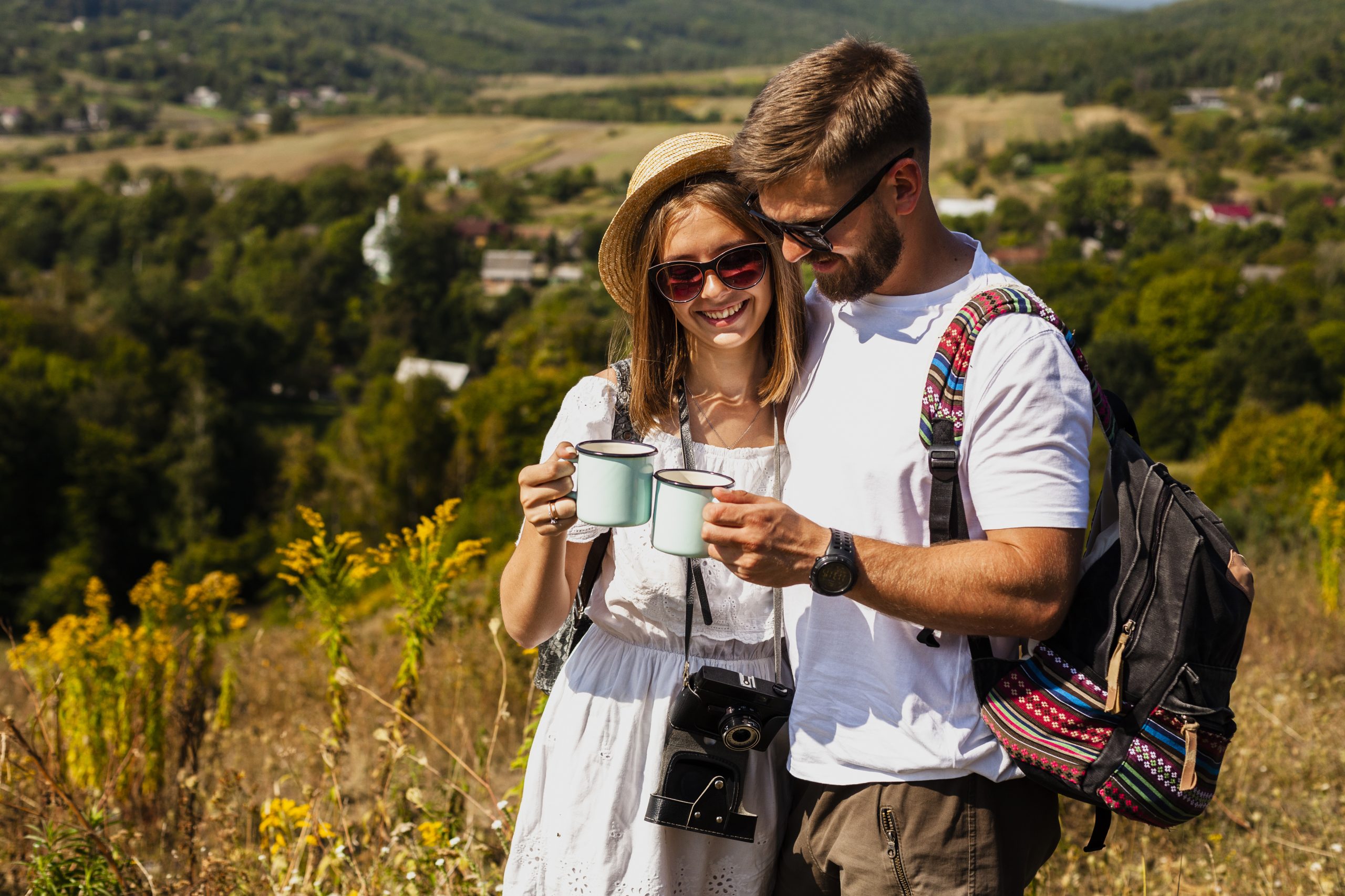 woman-man-holding a cup-nature-travellers