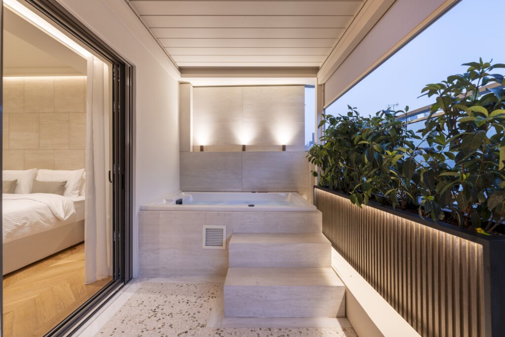 Private balcony with outdoor hot tub at Acropolis Luxury Penthouse in Koukaki, Athens