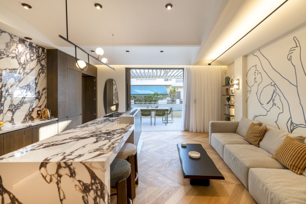 Open plan living room and fully equipped kitchen at Acropolis Luxury Penthouse in Koukaki, Athens