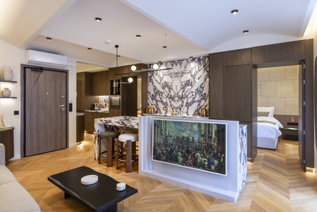 Open plan living room and fully equipped kitchen at Acropolis Luxury Penthouse in Koukaki, Athens