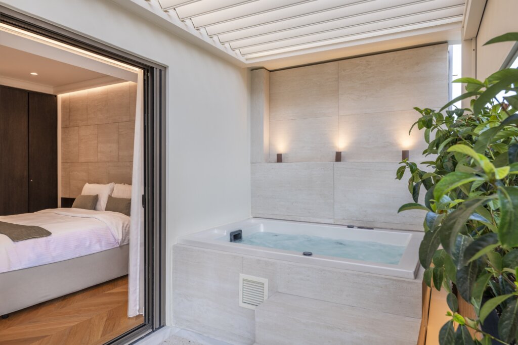 Private balcony with outdoor hot tub at Acropolis Luxury Penthouse in Koukaki, Athens