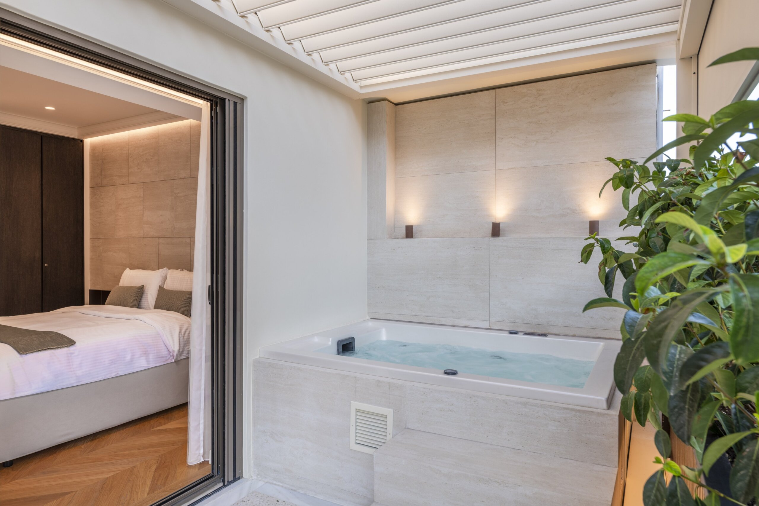Private balcony with outdoor hot tub at Acropolis Luxury Penthouse in Koukaki, Athens